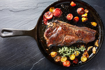 top down photo of a new york strip steak in iron skillet