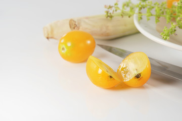 Yellow cherry tomato/Yellow cherry tomato on white table.
