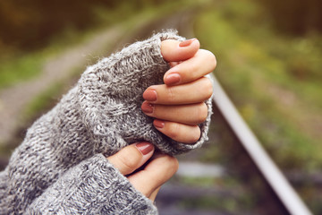 Female arms on railway tracks background
