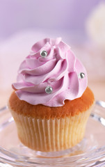 Tasty cupcake on stand, on light background
