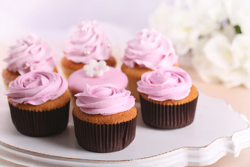 Tasty cupcakes on stand, close-up