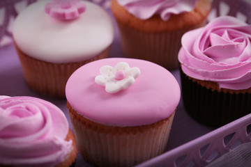 Tasty cupcakes on tray, close-up