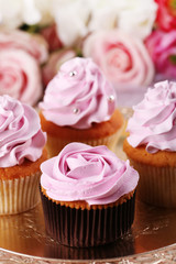 Tasty cupcakes on bright background
