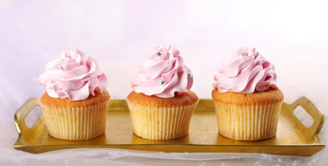 Tasty cupcakes on light background