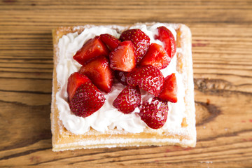 Waffles with whipped cream and raspberries and cranberries
