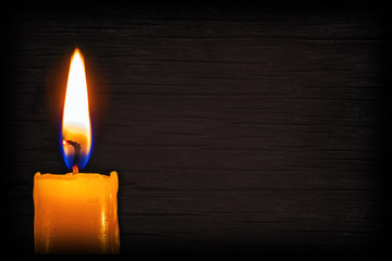 candle on a background with a wooden texture. wood background fo