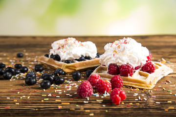 Waffles with whipped cream and raspberries and cranberries
