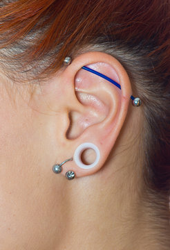 girl ear with piercings