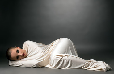 Wrapped girl with resigned expression on her face