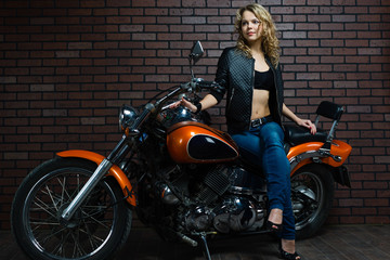 Fototapeta na wymiar blond girl on a motorcycle