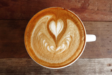 cup of latte art coffee on wooden background 