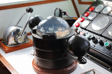 big compass on a boat showing direction on daytime