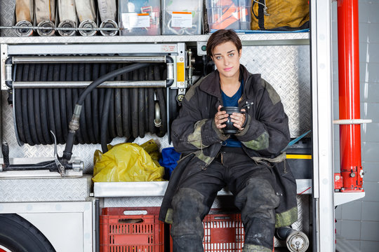 Confident Firewoman Holding Coffee Mug In Truck