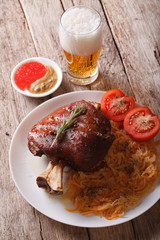 eisbein: baked pork shank and braised cabbage and beer. vertical
