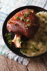 Baked shank and mashed potato on the plate closeup. Vertical
