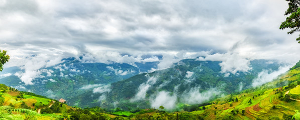Clouds on the northwestern highlands with clouds flying across the mountain below are terraces and barren hills. This is the most remote region of Ha Giang, Vietnam