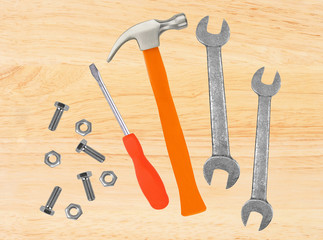 Hammer, screwdriver and wrenches on wooden table