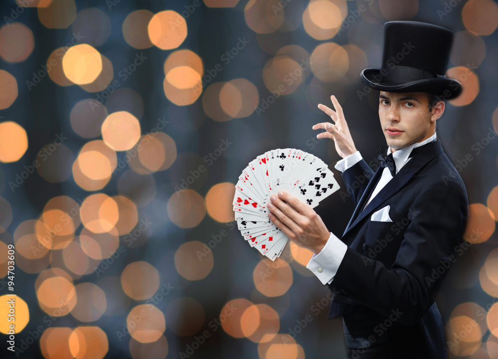 Wall mural magician showing trick with playing cards