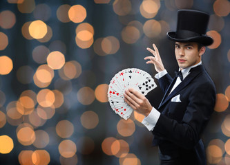 magician showing trick with playing cards