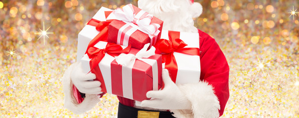 man in costume of santa claus with gift boxes