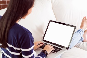 Fototapeta premium Asian woman on the couch using laptop