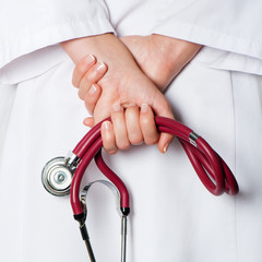 Red stethoscope in nurse hand