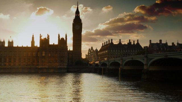 Pan from the Houses of Parliament to Westminster Bridge at sunset. Shot on a clear day in 4K