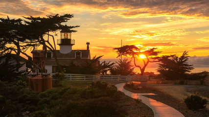 View of Point Pinos lighthouse on the Monterey coast at sunset © lucky-photo