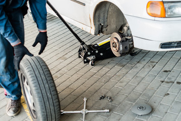 abstract blur out of focus for mechanic changing a wheel of a mo