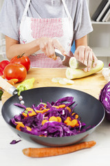 Preparing fresh organic food. Cutting vegetables