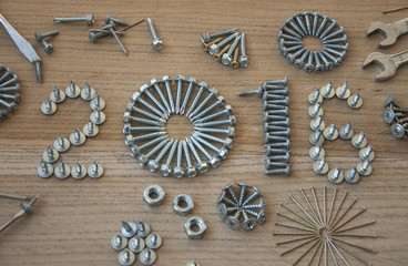 Happy new year 2016 composition with screws nails bolts and dowels