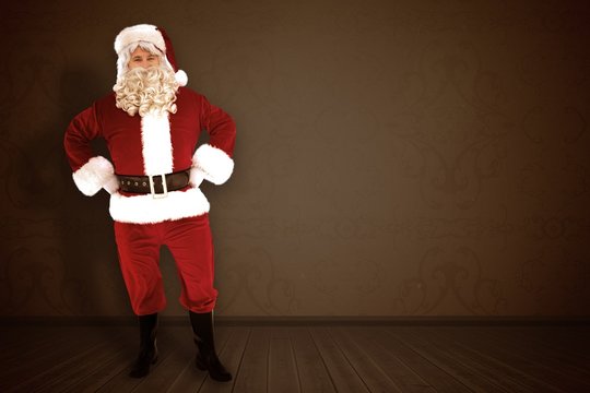 Composite image of portrait of santa claus with hands on hips