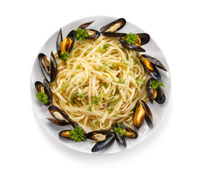 Cooked mussels and pasta on white background