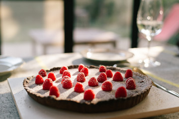 Delicious Chocolate Pie with Raspberries on top  powdered with icing sugar for Christmas dinner party