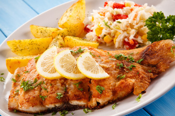 Fish dish - fried fish fillet baked potatoes and vegetables