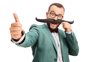 Man with fake moustache giving a thumb up