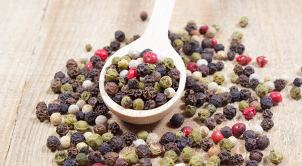 Color pepper on a wooden background.