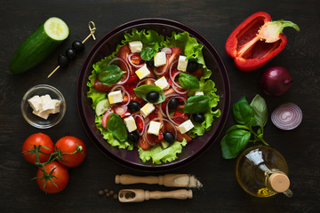 Fresh greek salad with Feta and vegetables on purple plate