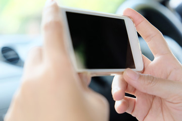 Woman Sitting in the Car and Using Smart Phone