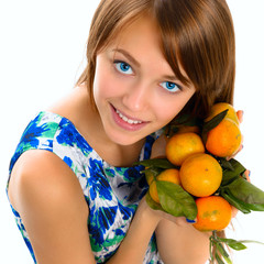 Portrait of a beautiful young girl with tangerines.