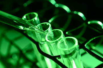 Pipette adding fluid to one of several test tubes