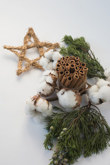 Naklejka na ściany i meble Christmas decorations eco cotton flowers, cinnamon,stars, spruce branches and jute rope hank over white background,holiday,xmas,christmas on white background