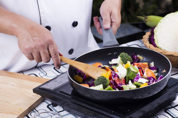 Chef cooking stir fried vegetable