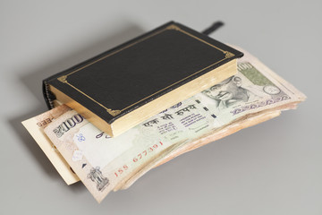 Book with Indian Currency Rupee bank notes