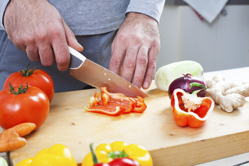 Preparing fresh organic food. Cutting vegetables