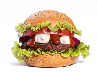 Big hamburger with beef cutlet and vegetables on white backgound