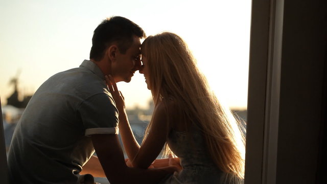Couple kissing on a city roof top