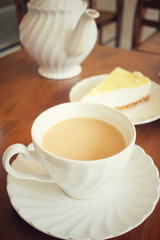 Obraz na płótnie Canvas Lemon cheese cake with milk tea