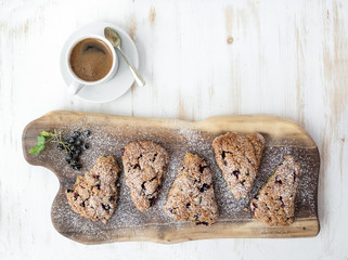 Fresh black-currant scones with cup of coffee , top view