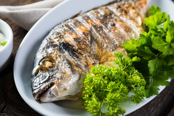 Grilled whole fish with greens